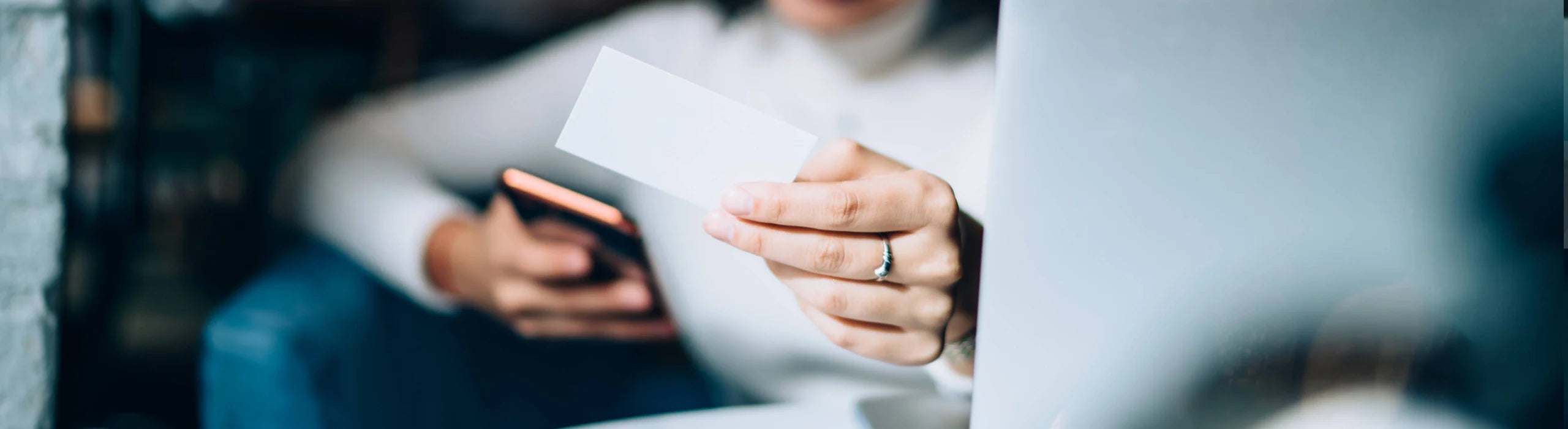 A woman handing out a business card.