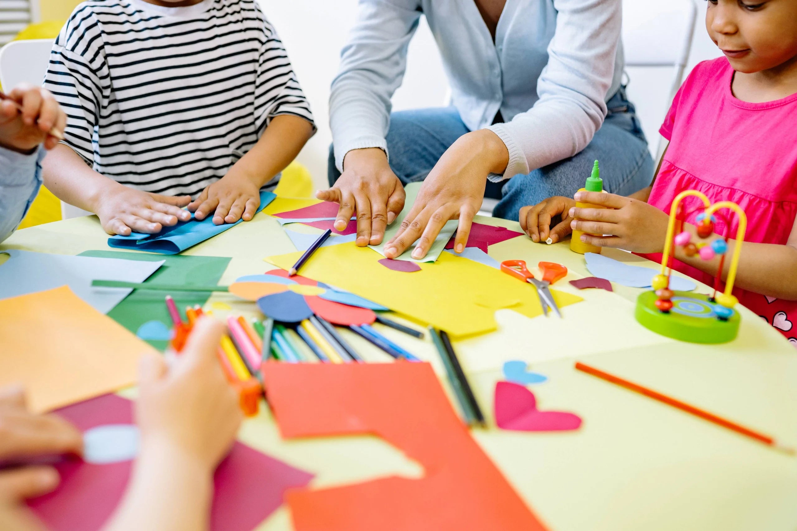 Students and teacher doing making crafts