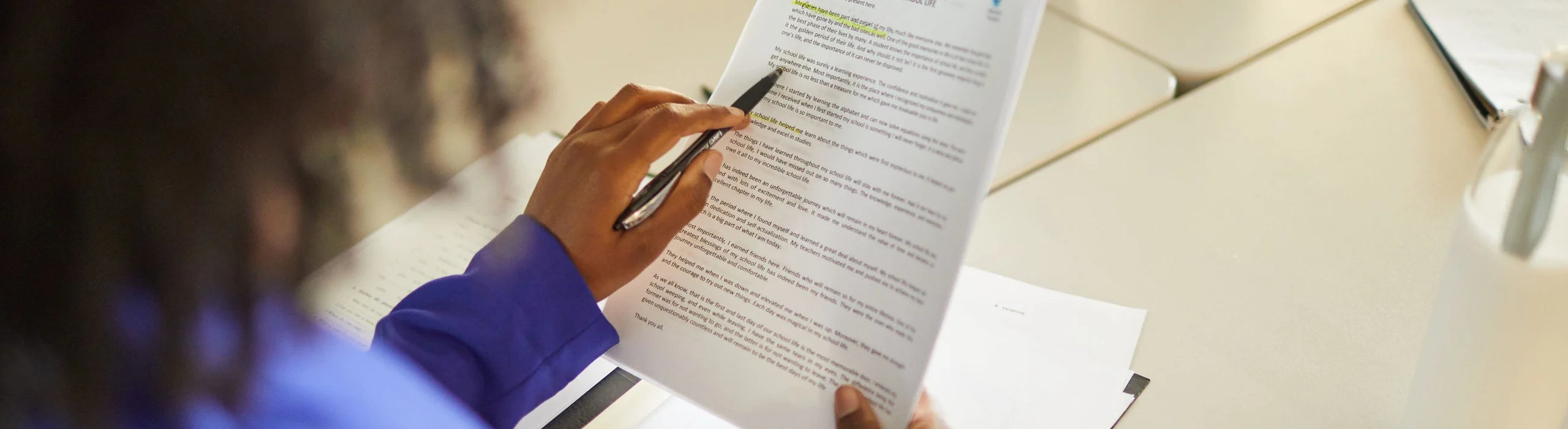 Person revising text on paper