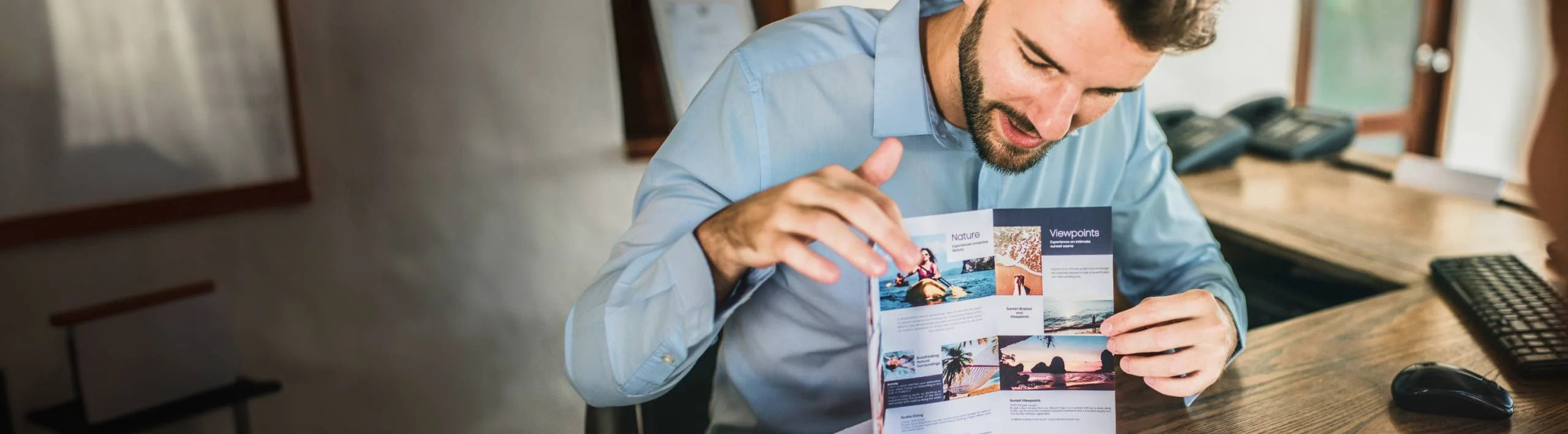 Man reading through a brochure