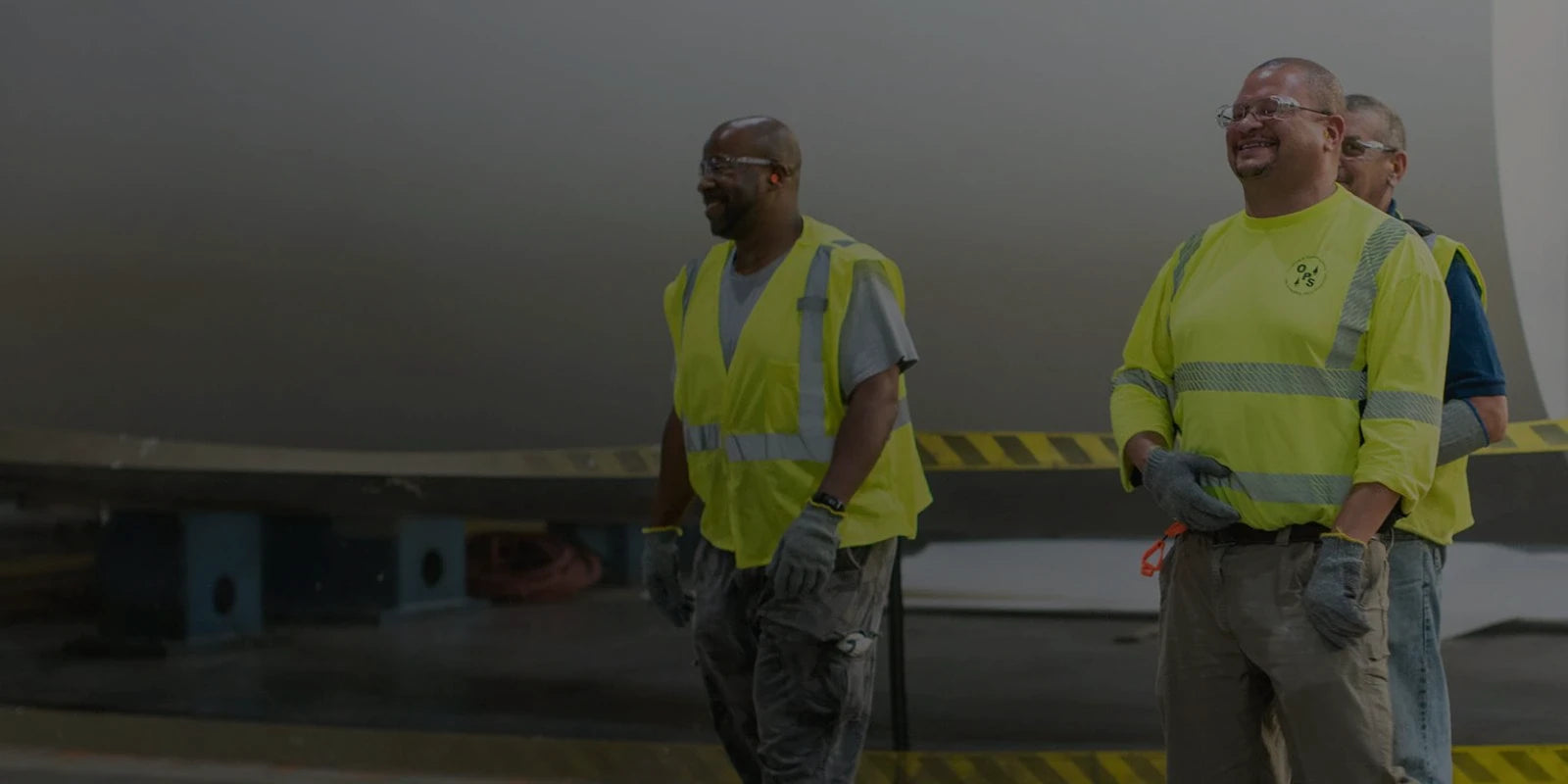 Three workers at a job site.