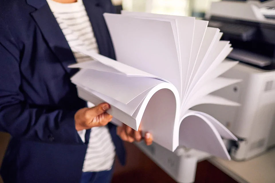 Person flipping through a stack of paper