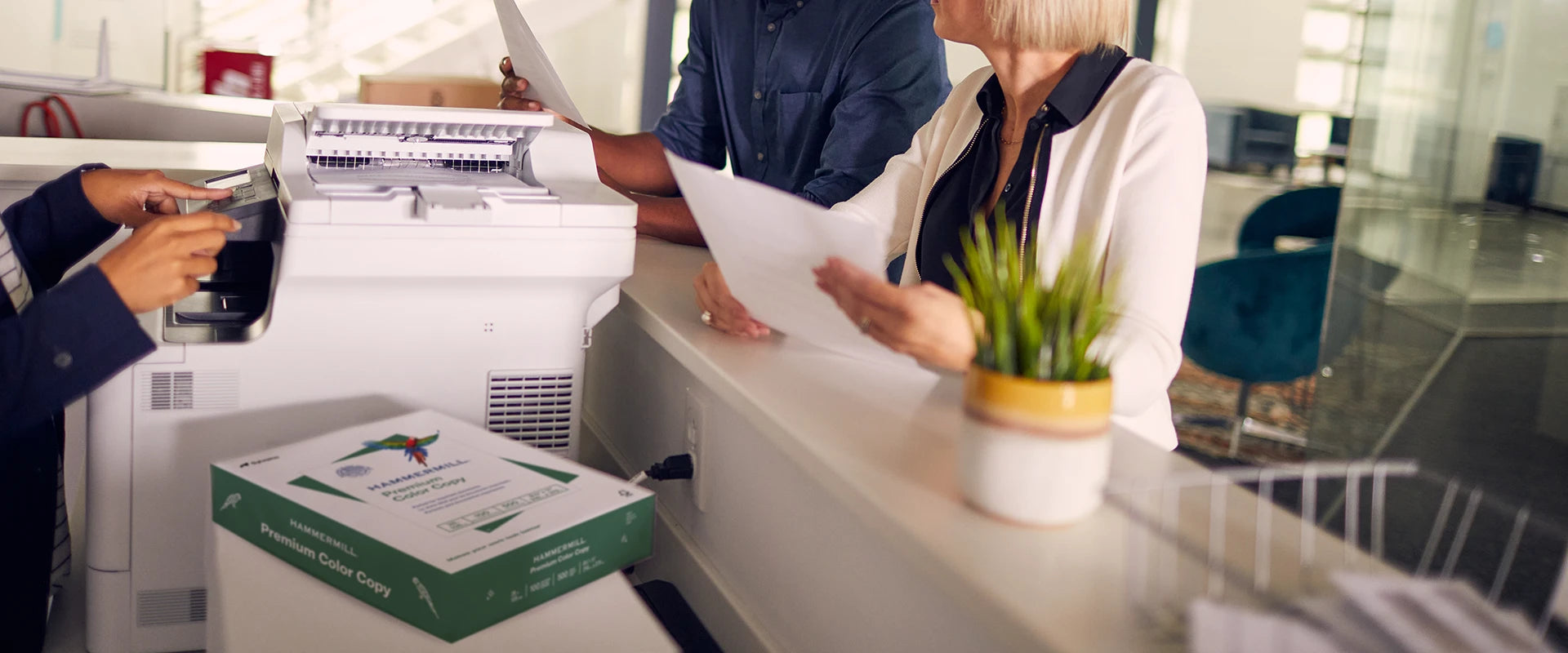 People standing around a printer