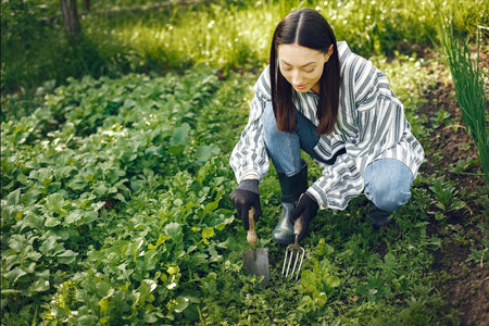 Woman planting in a garden