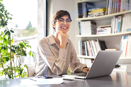 Woman working at a desk smiling