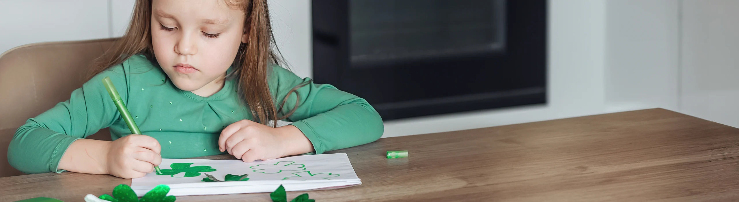 Child drawing clovers.