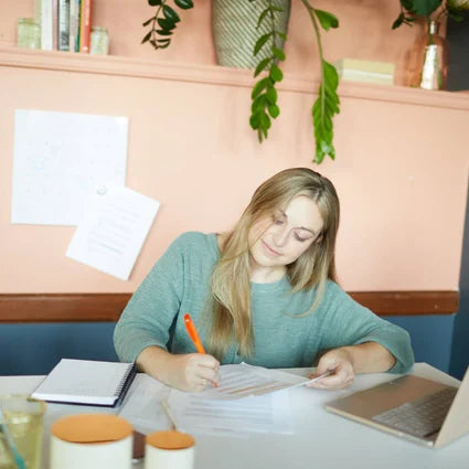 Woman writing and editing a press release