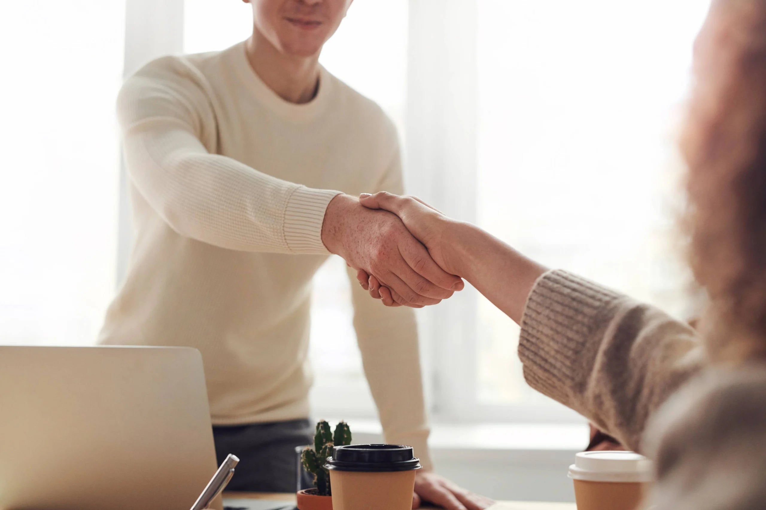 A closeup of two people shaking hands