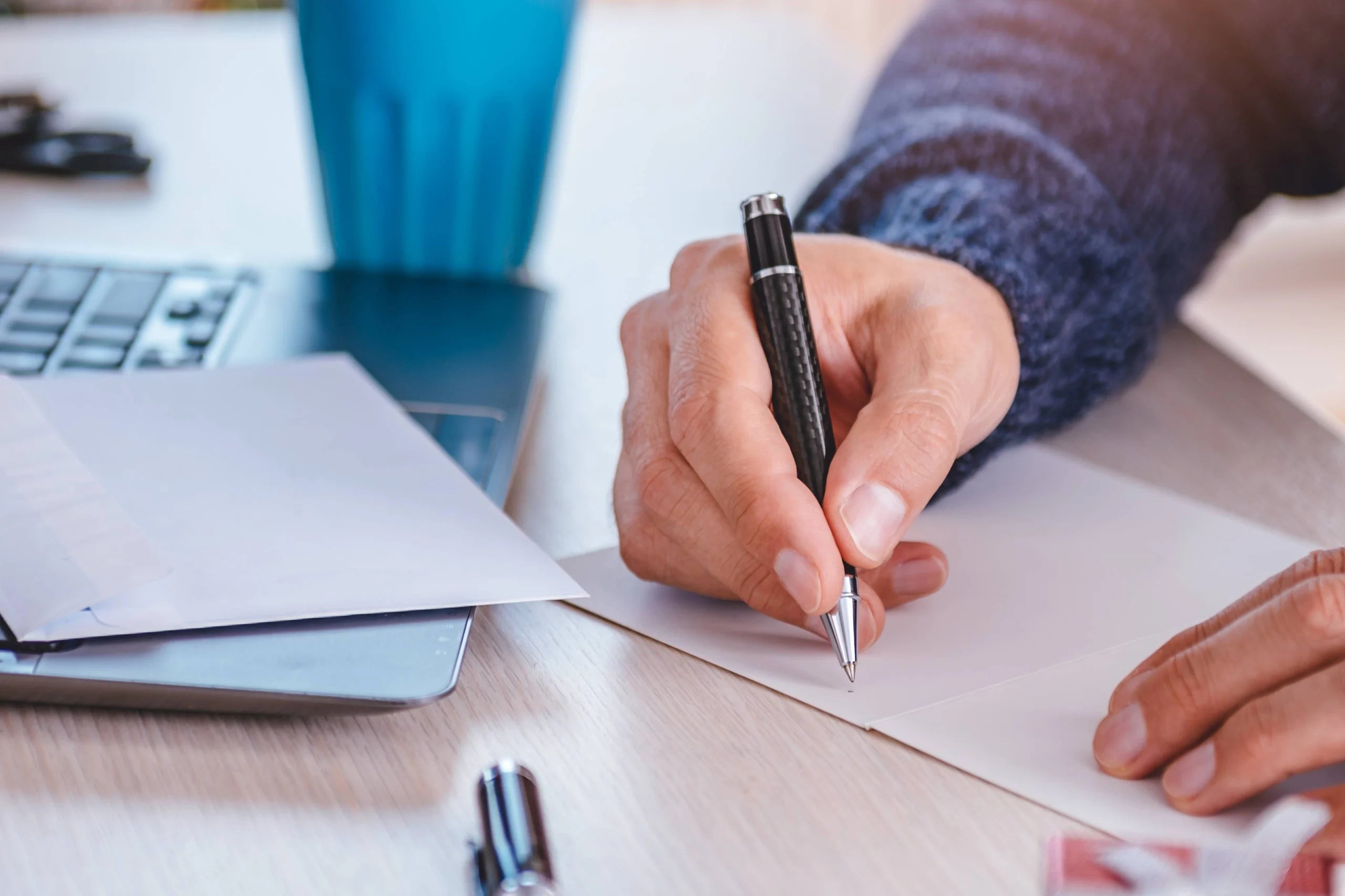 Person writing on a card