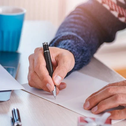 Person writing on a card
